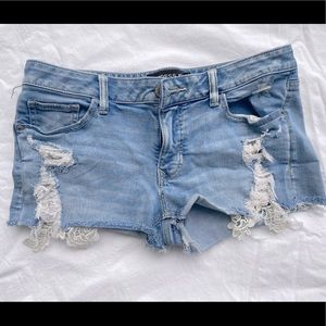 Distressed laced jean shorts